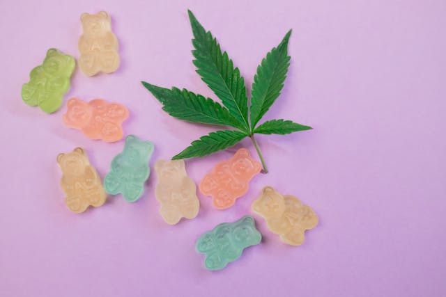 gummy bears with weed next to leaf